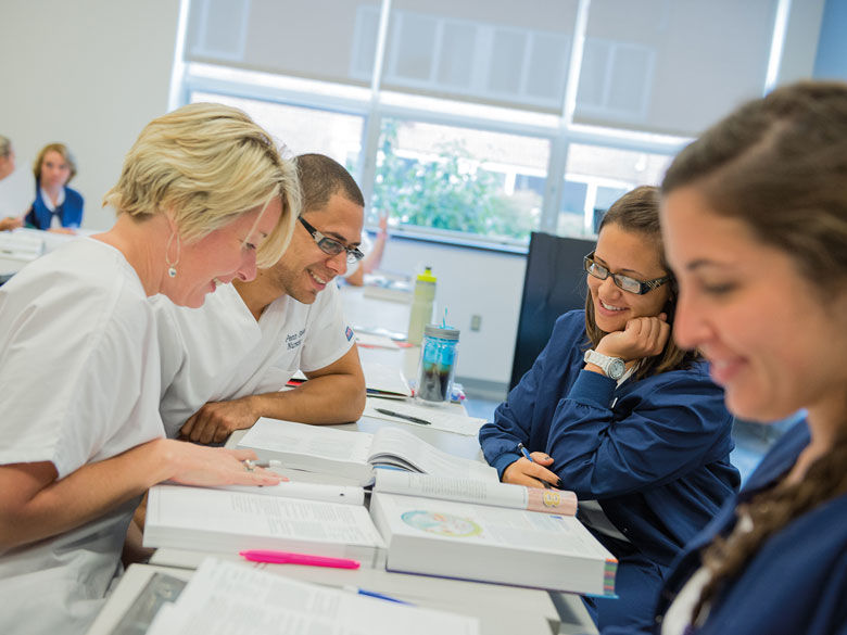 nursing students reading textbook